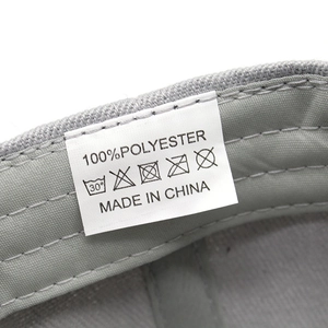 Detail view of the 100% polyester fabric care label with washing symbols and Made in China tag