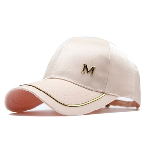 Detail of light pink satin baseball cap with gold metal M letter and metallic trim