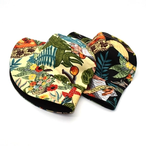 Detail of reversible cotton bucket hats with tropical floral prints in beige and black colors