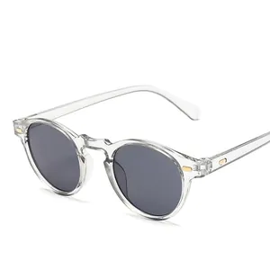 Retro round black sunglasses with dark lenses and gold rivet accents on white background