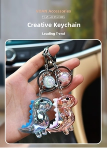 Iridescent acrylic dinosaur keychains in blue and pink with metallic carabiners