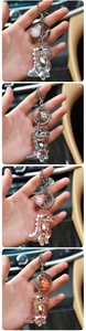 Macro shot of iridescent acrylic dinosaur keychains with liquid filling and metal rings