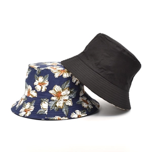 Detail of reversible bucket hats in navy floral print and classic solid black cotton canvas