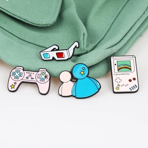 Set of 4 vintage gaming enamel pins featuring pink controller and retro handheld console