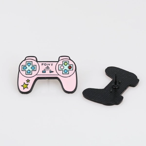 Detailed close-up of a pink game controller enamel pin with a star pattern and metal pin back