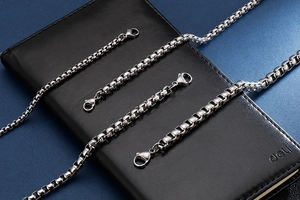 Detailed macro view of square box chain in silver steel with a classic lobster clasp