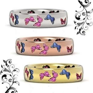 Detailed view of three butterfly rings in silver, rose gold and gold with zircon