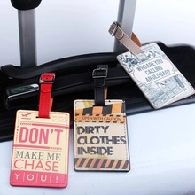 Close-up of three PU leather luggage tags with humorous quotes and metal buckles