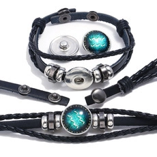 Braided leather multilayer bracelet featuring interchangeable zodiac snap button charms