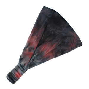 Detail of wide tie-dye yoga headband with retro patterns and elastic back band