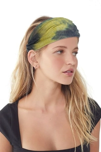 Detail of a tie-dye wide elastic yoga headband in yellow and olive on a female model