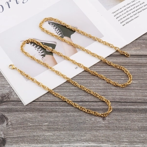 Elegant gold twisted rope chain necklace with lobster clasp on a stylish magazine