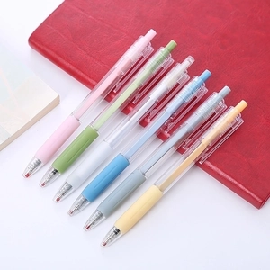 Set of six colorful retractable gel pens on a red notebook for students and office