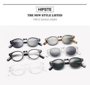Detail view of vintage round sunglasses in black, tortoise, and transparent gray frames