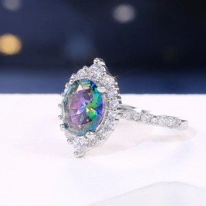 Macro detail of silver ring with oval mystic topaz and pave-set cubic zirconia accents