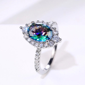 Detailed top view of mystic topaz ring with oval gemstone and cubic zirconia halo