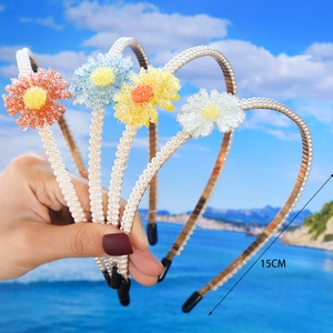 Handmade 15cm daisy pearl headband featuring colorful beaded flowers in a beach setting