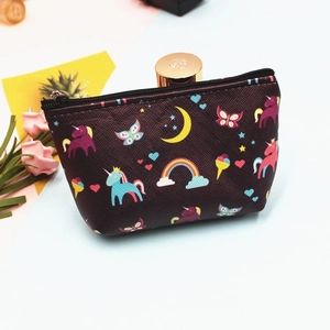 Detail of a purple unicorn coin purse showing colorful rainbow prints and a smooth black zipper