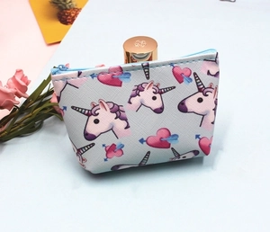 Detail of cross-grain unicorn coin purse with blue zipper and heart patterns