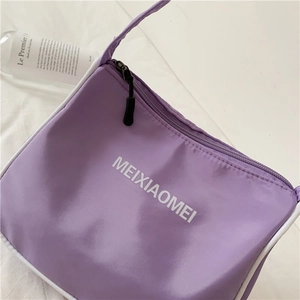 Purple nylon underarm bag with zipper closure and logo detail on white background