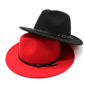 Top-down view of red and black wool fedora hats with leather belts and metal buckles