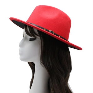 Red wool fedora hat with black leather belt and gold studs on a mannequin head