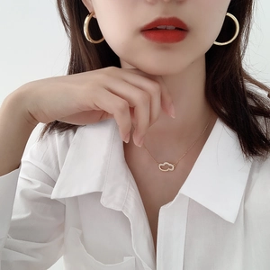 Detail of elegant gold S925 sterling silver large C-shaped hoop earrings and necklace set
