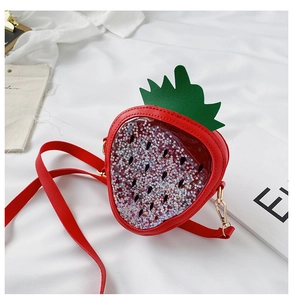 Detail of red strawberry sequin bag for girls with sparkling star-shaped confetti