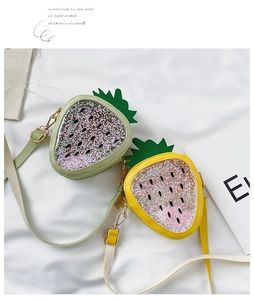 Detail of strawberry crossbody bag showing yellow and green sequin PU leather texture