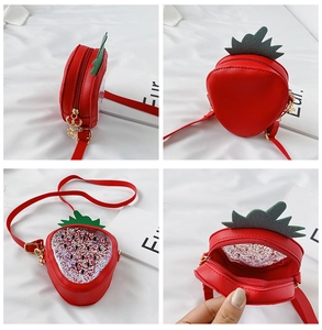 Detail view of red strawberry sequin crossbody bag with PU leather and gold hardware