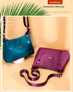 Detail of teal and burgundy waterproof nylon crossbody bags with adjustable straps