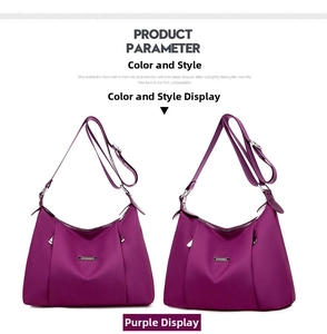 Detail view of purple nylon crossbody bag with adjustable straps and metal zippers