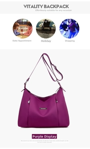 Detail of purple waterproof hobo bag with silver zippers and adjustable shoulder strap