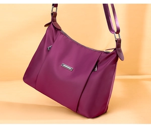 Detailed view of the purple nylon shoulder bag with silver zipper and metallic accents
