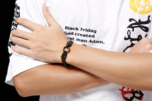 Detail of men's punk black wolf head bracelet with ring clasp on model's wrist