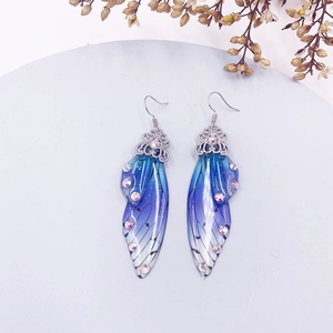 Macro detail of gradient blue butterfly wing earrings with rhinestones on S925 hooks