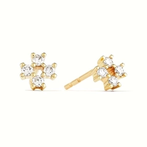 Macro detail of gold geometric stud earrings with clear cubic zirconia in four-prong settings