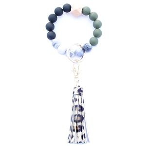 Detail of beaded keychain bracelet with leopard tassel and gold hardware