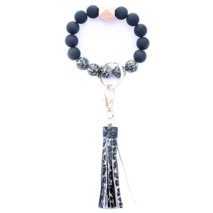 Detailed shot of leopard print silicone beads and PU leather tassel on keychain bracelet
