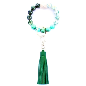 Detail of green leopard print and marble beads with a leather tassel keychain