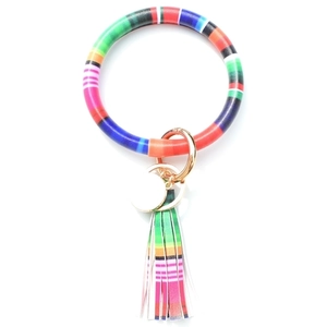 Detail view of colorful tie-dye PU leather wristlet keychain with fringe tassel and gold ring