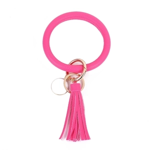 Close-up of pink PU leather wristlet keychain with golden ring and tassel detail