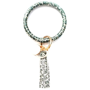 Detail of leopard print PU leather wristlet keychain with gold clasp and tassel charm
