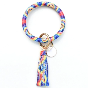 Detail of tie-dye wristlet keychain with leather tassel and gold metal ring
