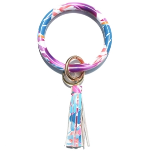 Detail of colorful feather print leather bracelet with golden ring and tassel charm