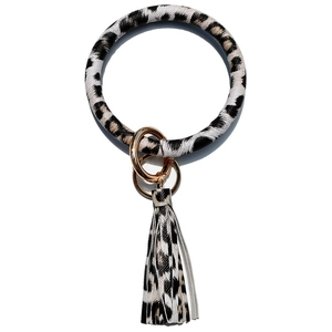 Detail of leopard print wristlet keychain with golden metal ring and tassel charm