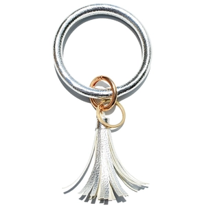 Detail of silver lychee leather keychain bracelet with golden rings and long tassel