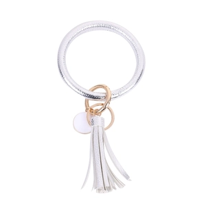 Detail view of silver PU leather ring keychain with gold clasp and matching tassel