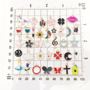 Assorted colorful enamel charms in unicorn, cat and heart shapes with gold metal base