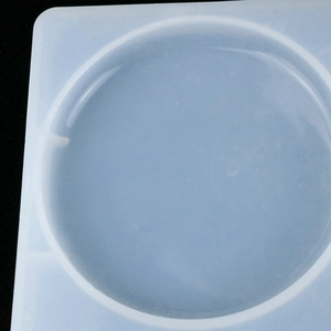 Close-up of a translucent white round silicone mold for DIY resin and plaster crafts